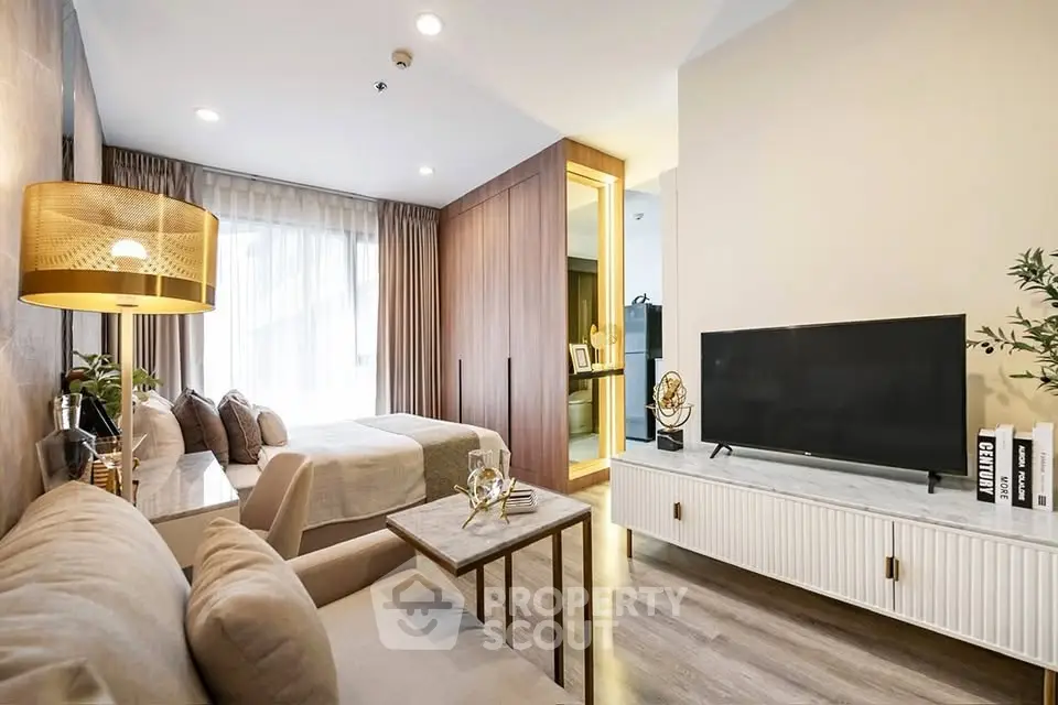 Modern studio apartment with stylish decor and open layout, featuring a cozy living area and elegant bedroom.