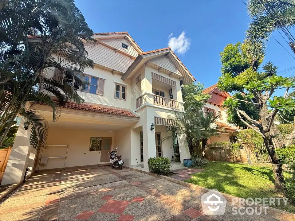 Charming two-story house with lush garden and spacious driveway in serene neighborhood.