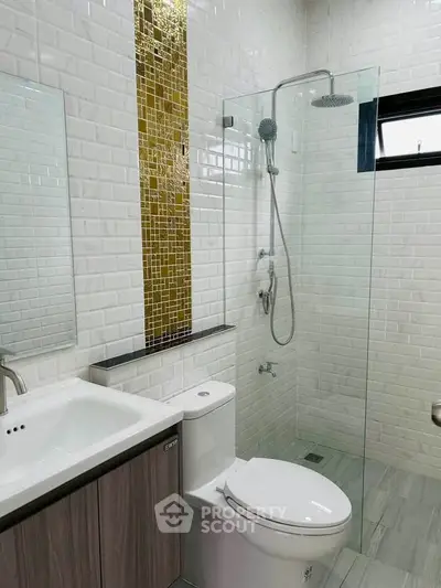 Modern bathroom with glass shower and stylish tile accents