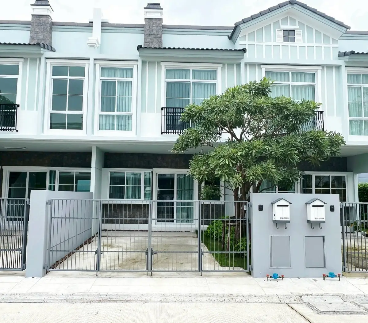 Charming townhouse with modern facade and gated entrance