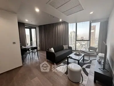 Modern living room with city view, stylish furniture, and elegant decor in a high-rise apartment.