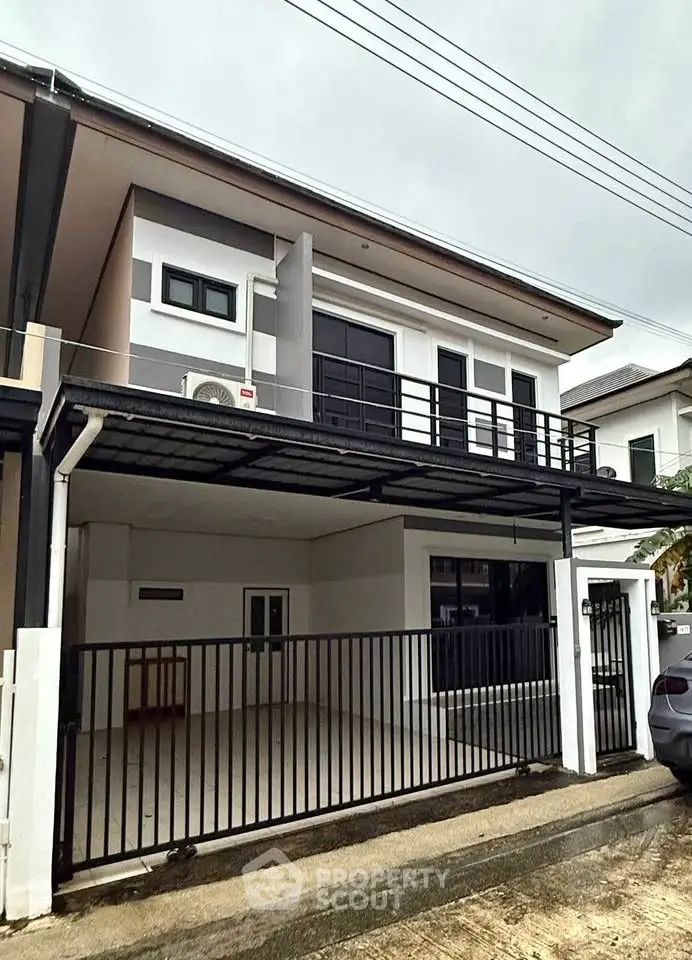 Modern two-story house with spacious carport and sleek design