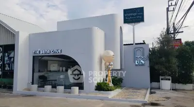 Modern commercial building with unique architecture and signage, ideal for business opportunities.