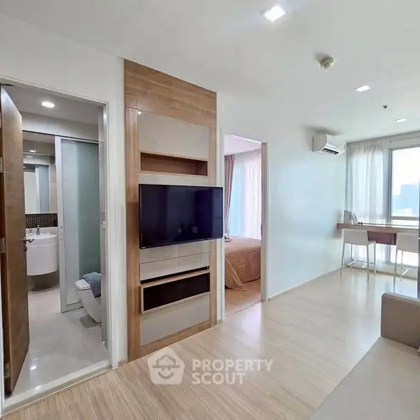Modern apartment interior with open living space and bedroom view