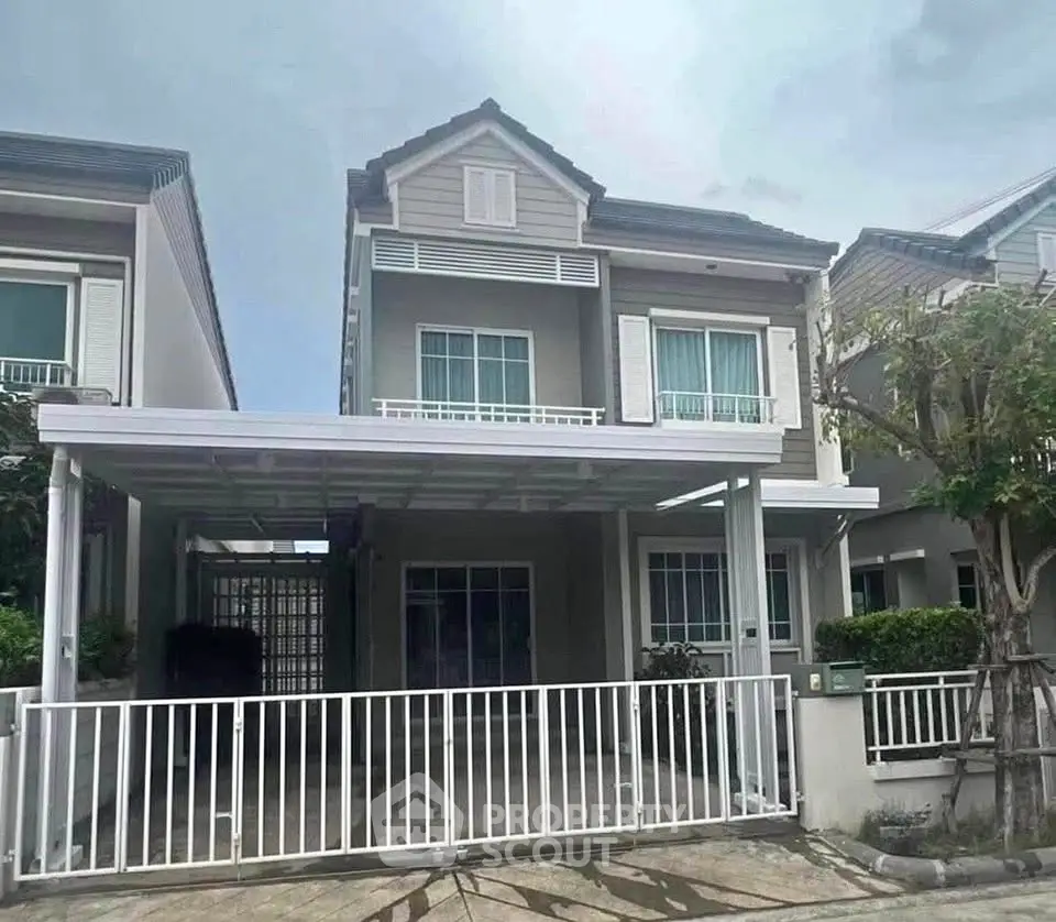Charming two-story house with modern design and spacious front yard in a serene neighborhood.