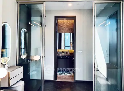 Luxurious modern bathroom with glass doors and elegant lighting