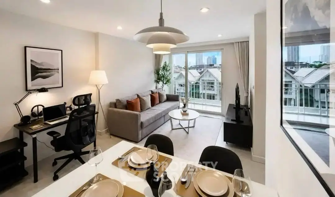 Modern living room with stylish decor and city view, featuring a cozy workspace and dining area.