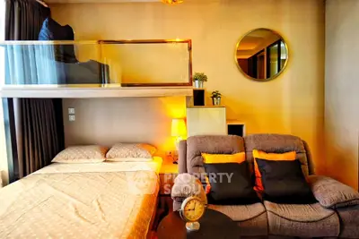 Cozy modern bedroom with loft, stylish decor, and comfortable seating area.