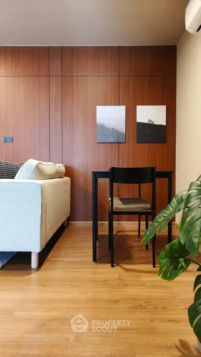 Modern living room with wooden wall panels and cozy seating area