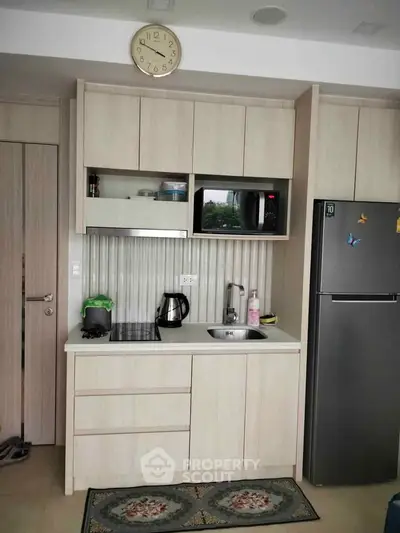 Modern compact kitchen with sleek cabinetry and appliances