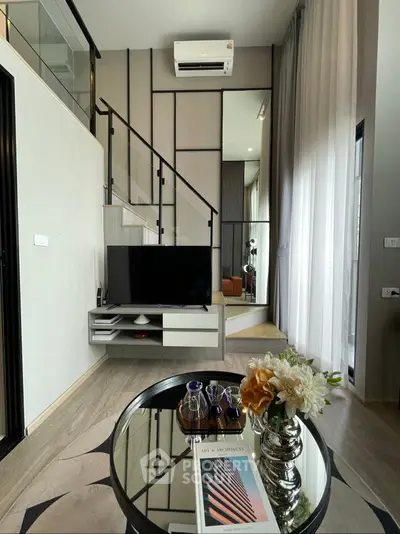Modern living room with high ceilings, stylish decor, and mezzanine level, perfect for contemporary living.