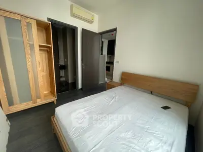 Modern bedroom with wooden furniture and air conditioning, featuring a minimalist design and ample natural light.