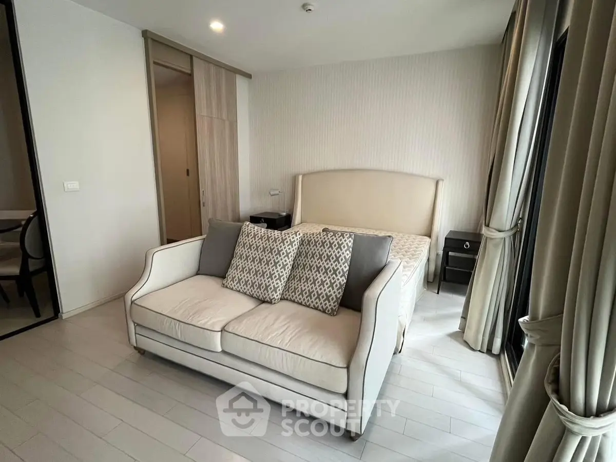Chic bedroom with elegant sofa and stylish decor in modern apartment