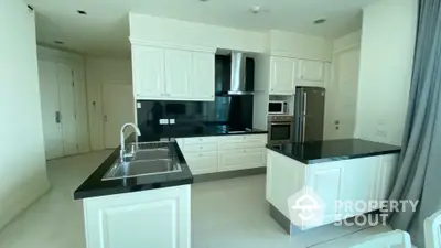 Modern kitchen with sleek black countertops and white cabinetry