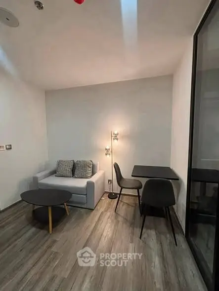 Modern living room with sleek furniture and stylish lighting in a cozy apartment.