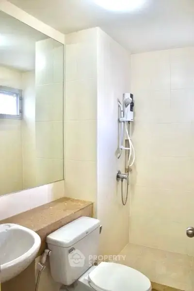 Modern bathroom with shower and sleek fixtures in a bright, minimalist design.