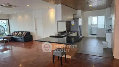 Spacious open-plan living room with modern kitchen and stylish decor.
