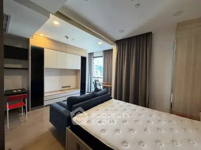 Modern bedroom with stylish furniture and natural light, featuring a cozy bed and a functional workspace.