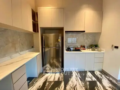 Modern kitchen with sleek cabinetry and stainless steel fridge