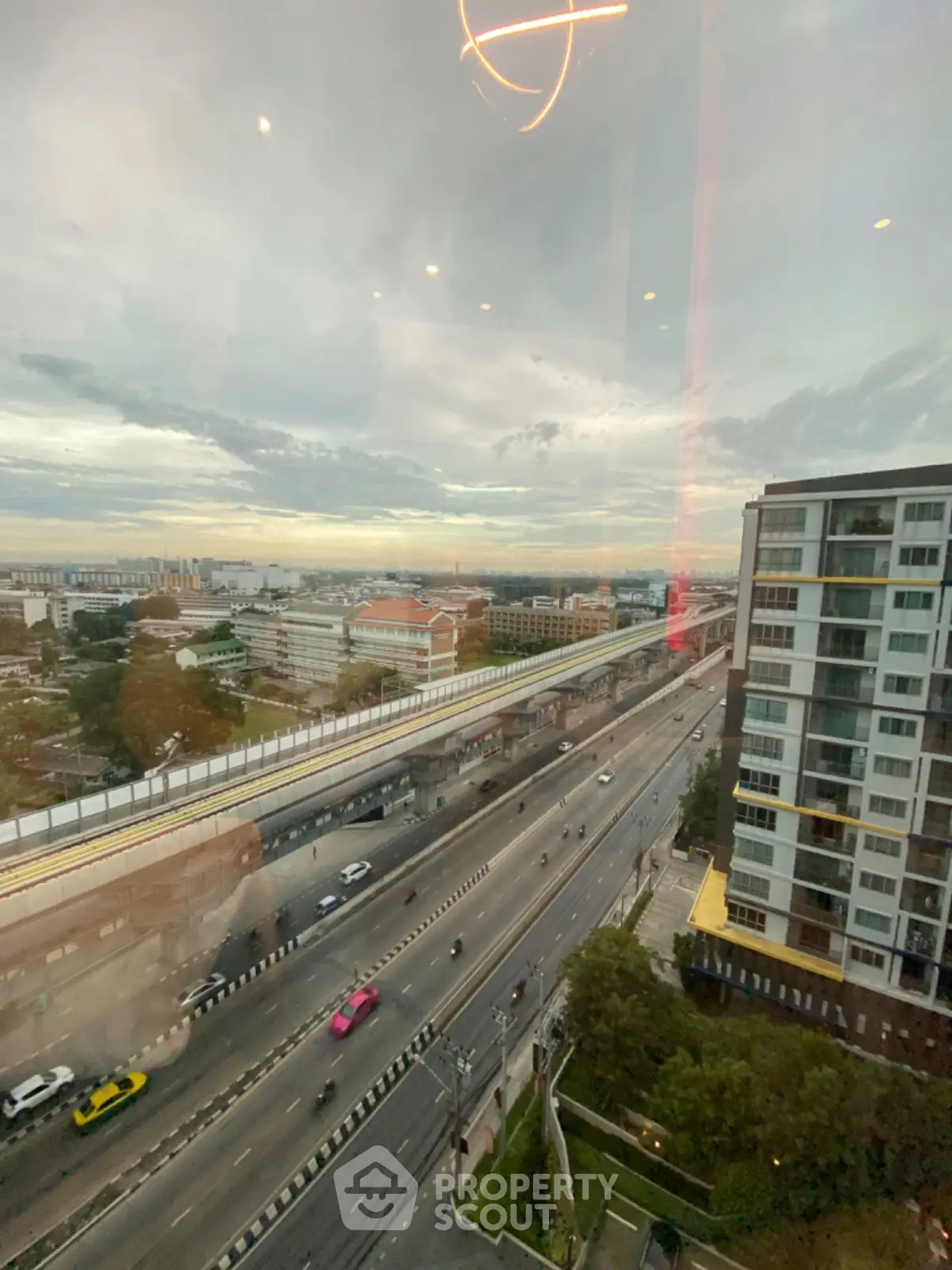 Stunning cityscape view from high-rise building with urban skyline and highway.