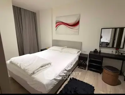 Modern bedroom with stylish decor and cozy ambiance, featuring a comfortable bed and elegant furnishings.