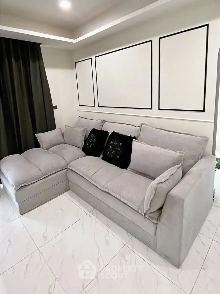 Modern living room with elegant gray sofa and stylish decor