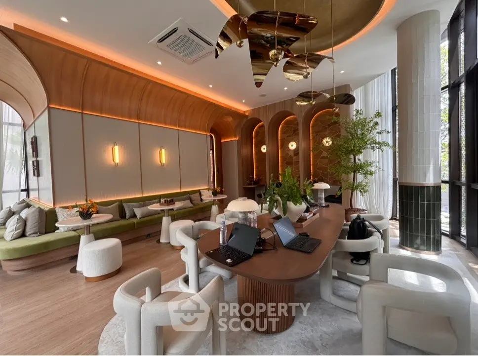 Luxurious modern living room with elegant decor and natural lighting, featuring stylish furniture and greenery.