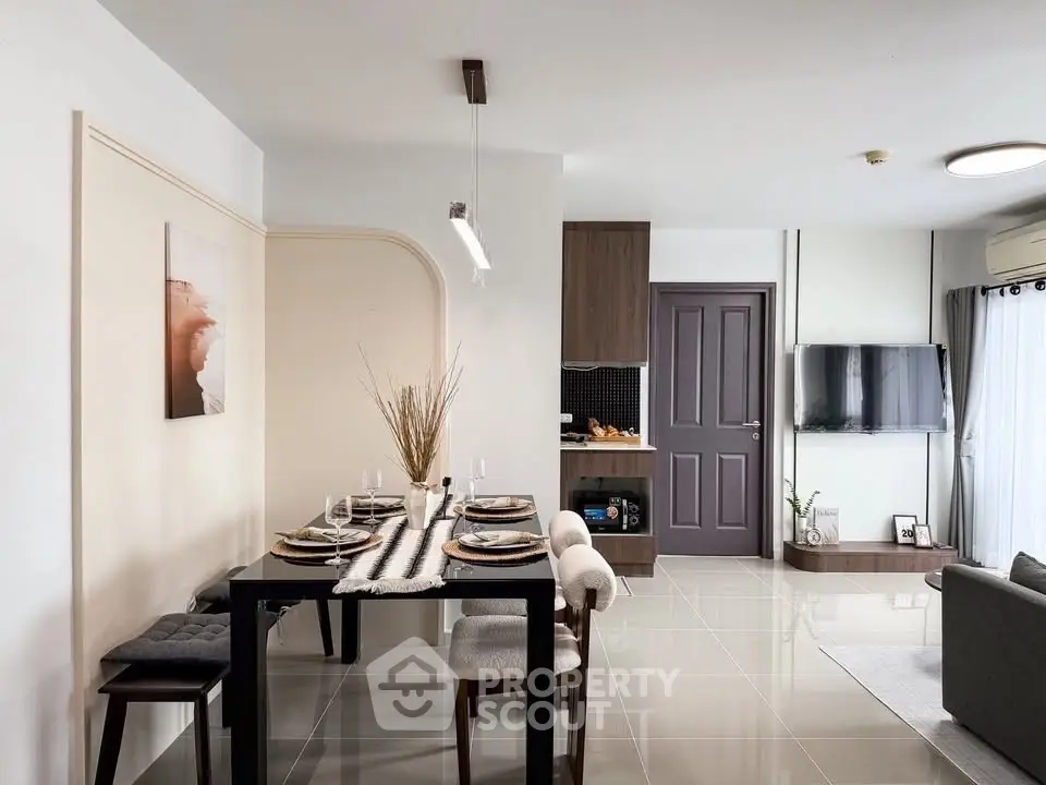 Modern open-plan living and dining area with stylish decor and natural light.