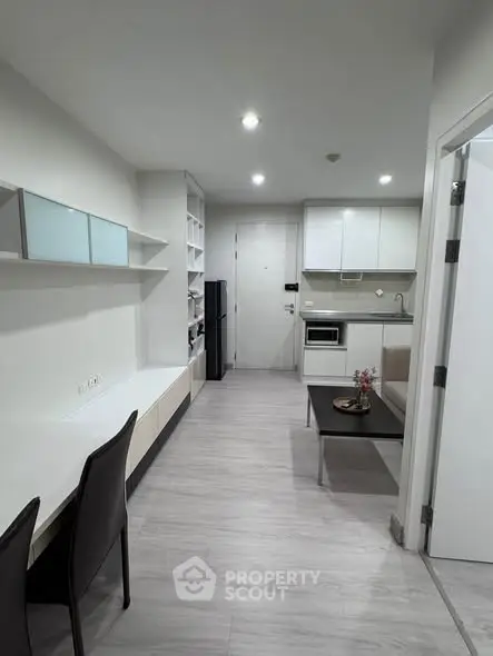 Modern apartment interior with sleek kitchen and cozy living area, perfect for urban living.
