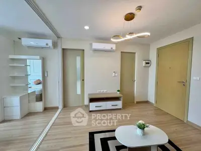Modern living room with stylish lighting and mirrored wall in a cozy apartment.