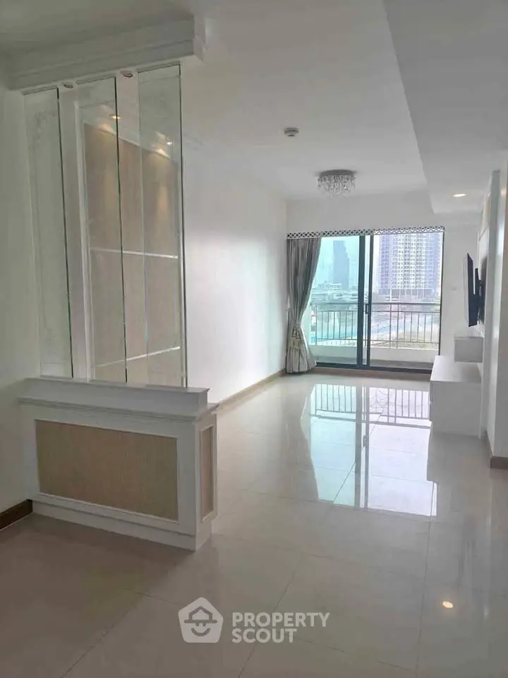 Spacious living room with large windows and city view, perfect for modern urban living.
