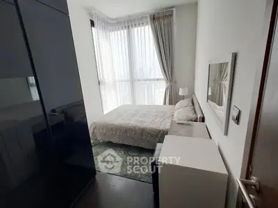 Cozy modern bedroom with large window and elegant decor