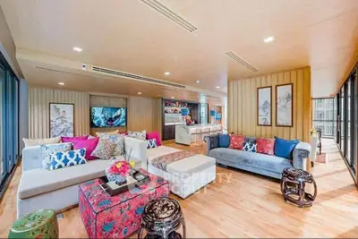 Spacious and colorful living room with modern decor and ample natural light.