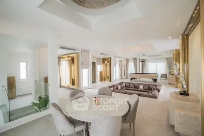 Luxurious open-plan living room with elegant decor and sunken seating area, perfect for entertaining.
