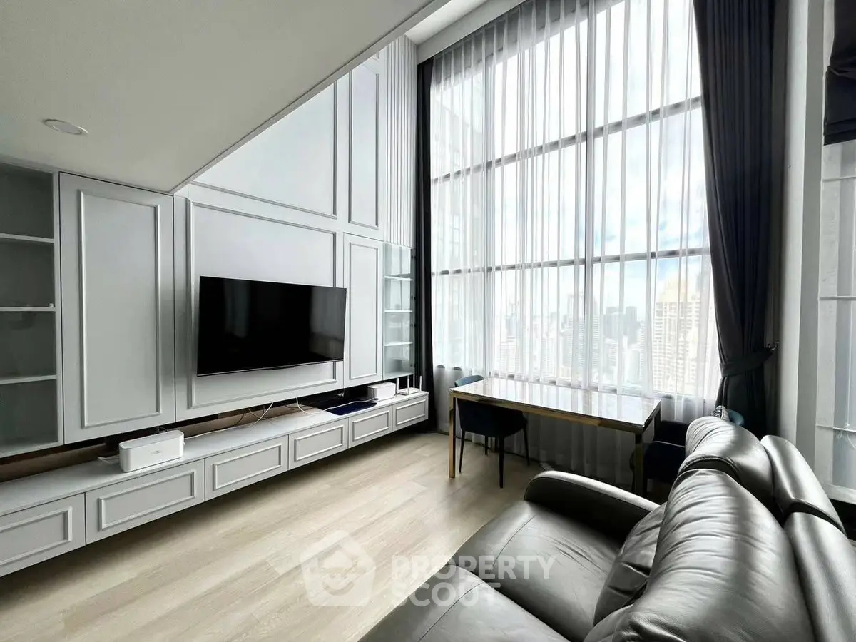 Luxurious high-rise living room with floor-to-ceiling windows and stunning city view.