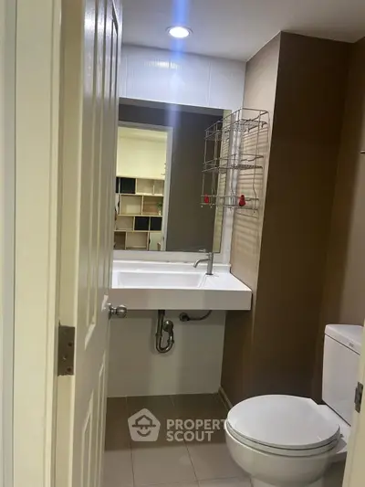 Compact bathroom with modern fixtures and neutral tones