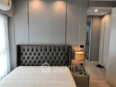 Luxurious bedroom with elegant decor and plush headboard in modern apartment