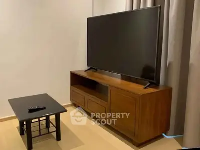 Modern living room with sleek TV stand and flat-screen TV, perfect for entertainment.