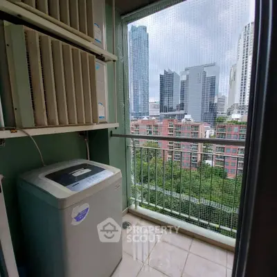 High-rise balcony with city view and washing machine, perfect for urban living.