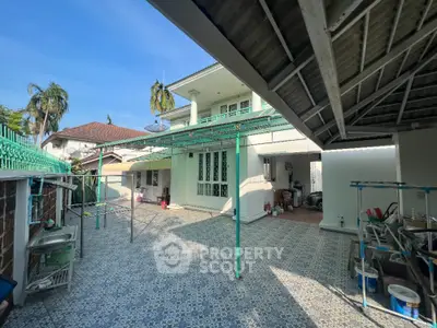 Spacious residential property with tiled courtyard and covered parking area