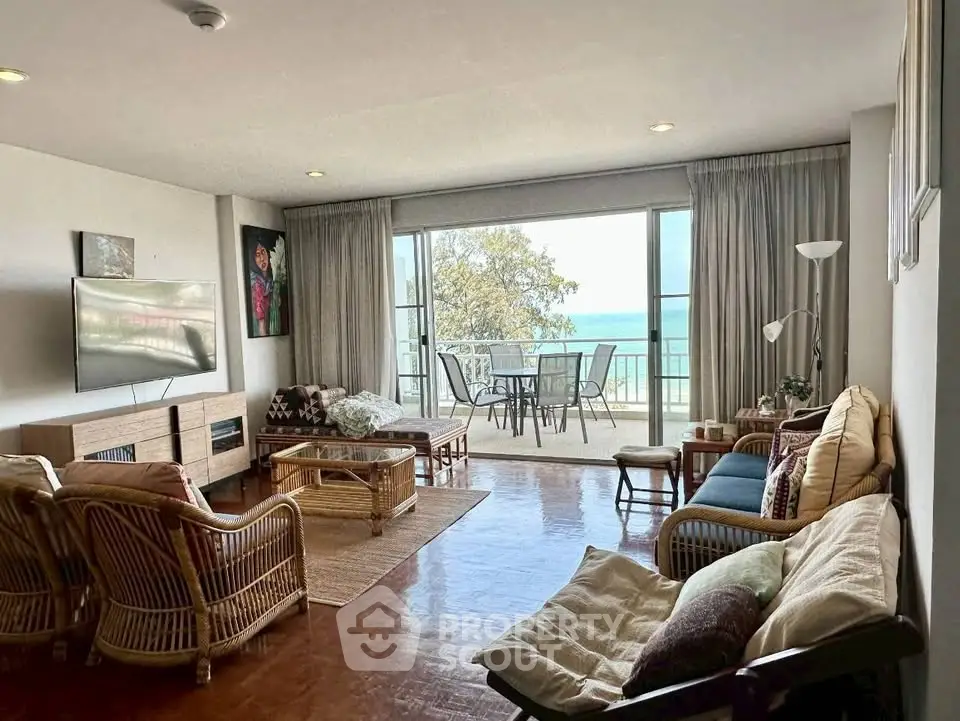 Spacious living room with ocean view and large balcony, perfect for relaxation and entertaining.