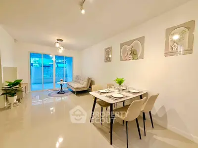 Spacious modern living room with elegant dining area and large windows for natural light.
