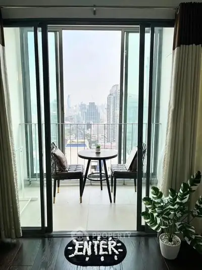 Stylish balcony with city view, featuring modern furniture and greenery, perfect for relaxation.