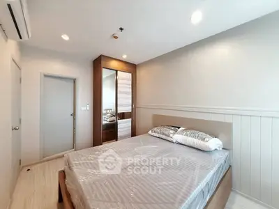 Modern bedroom with sleek design and ample natural light, featuring a comfortable bed and stylish wardrobe.