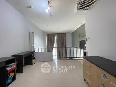 Spacious modern living area with sleek flooring and natural light