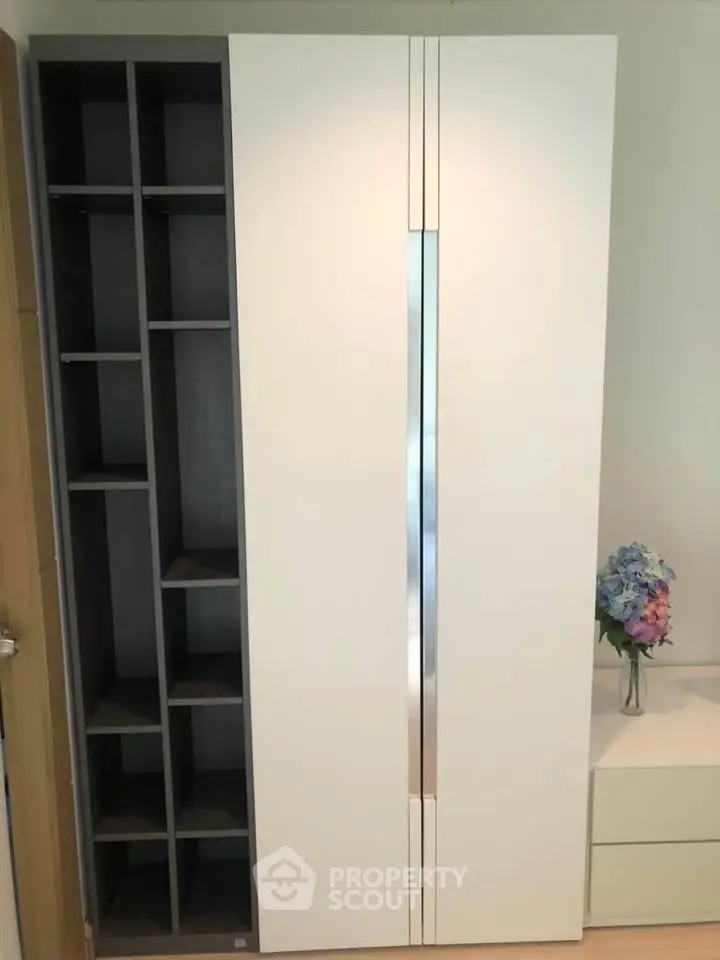 Modern storage cabinet with sleek design and adjacent decorative elements in a stylish interior.