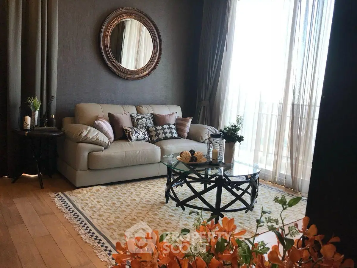 Elegant living room with stylish decor, large window, and cozy seating area.