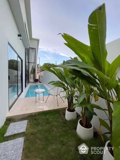 Modern villa with private pool and lush garden, perfect for relaxation and luxury living.