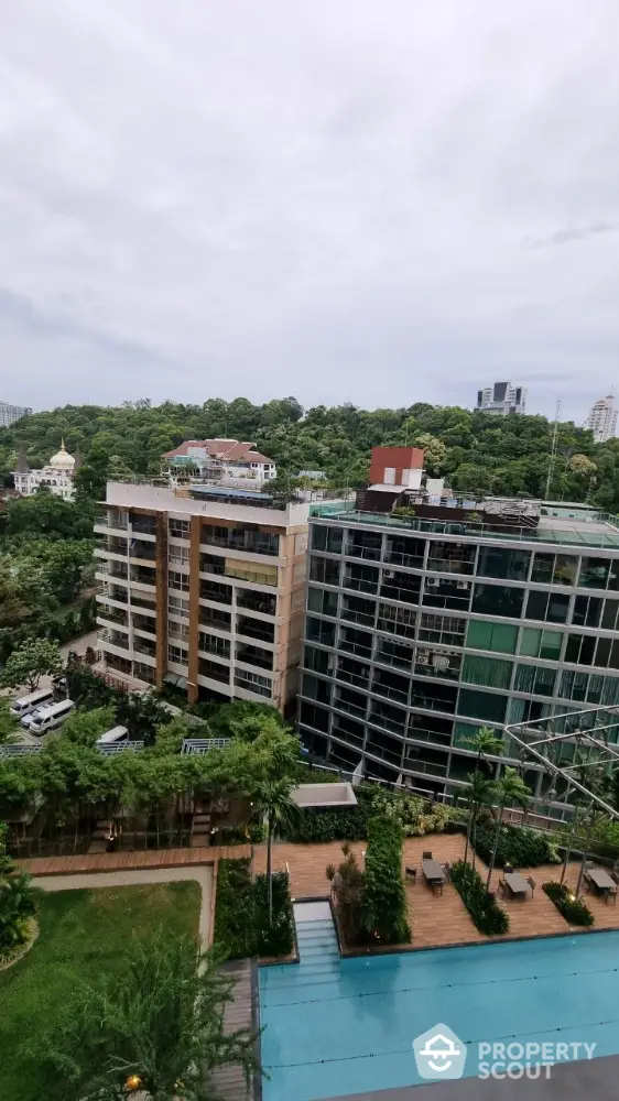 Luxurious condominium with pool and lush greenery view