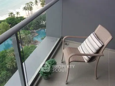 Stunning balcony view with ocean and pool, perfect for relaxation.